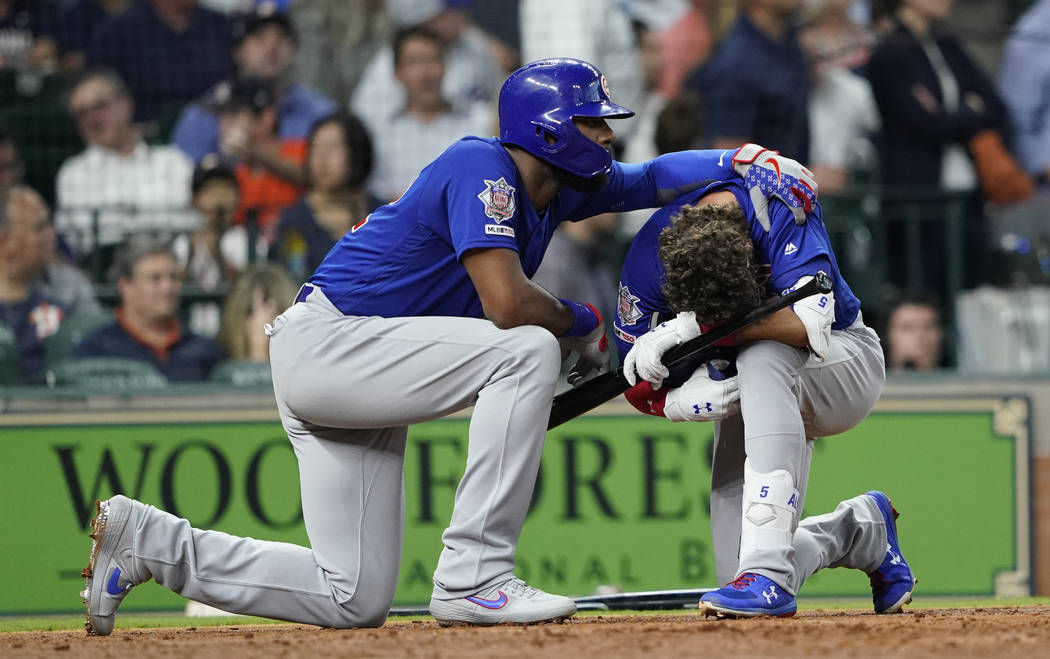 Chicago Cubs' Albert Almora Jr., right, is comforted by Jason Heyward after hitting a foul ball ...