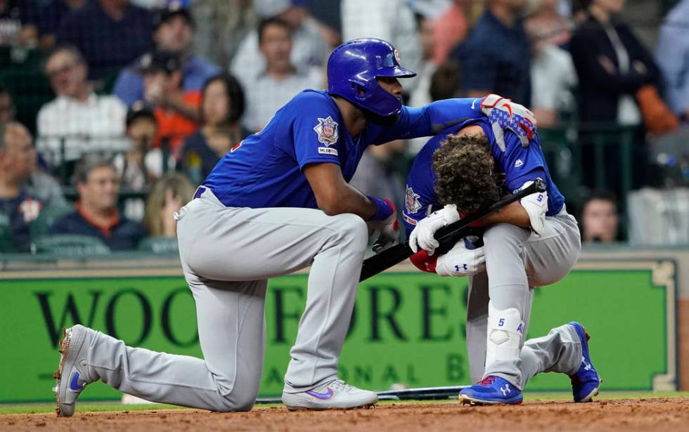 Chicago Cubs' Albert Almora Jr., right, is comforted by Jason Heyward after hitting a foul ball ...