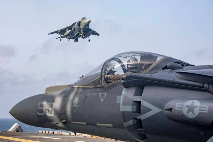 In this May 18, 2019 photo, AV-8B Harriers return to the flight deck of the Wasp-class amphibio ...