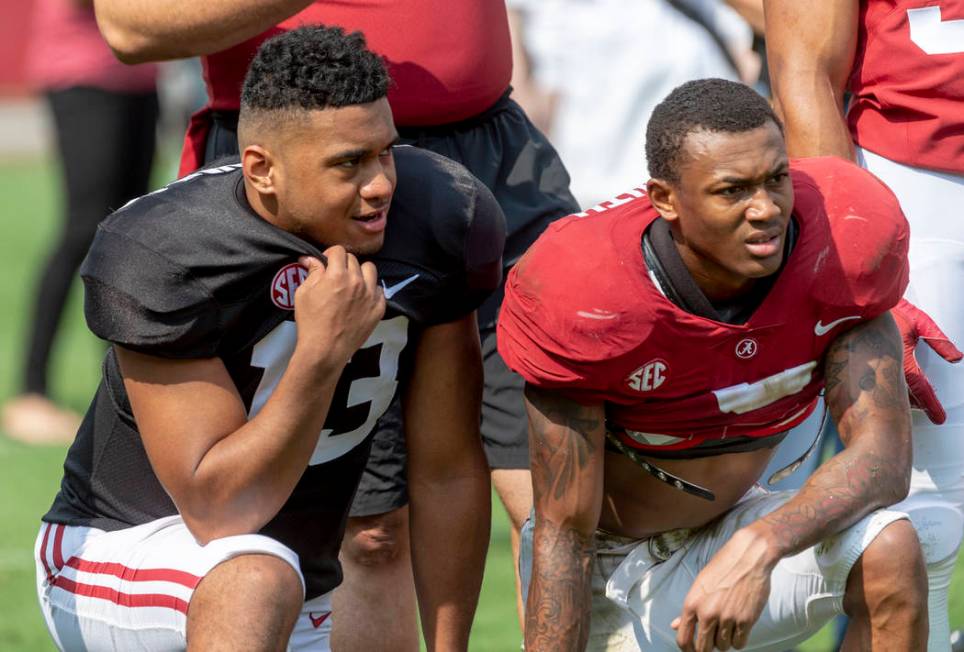 Alabama quarterback Tua Tagovailoa (13) and Alabama wide receiver DeVonta Smith (6) look on dur ...