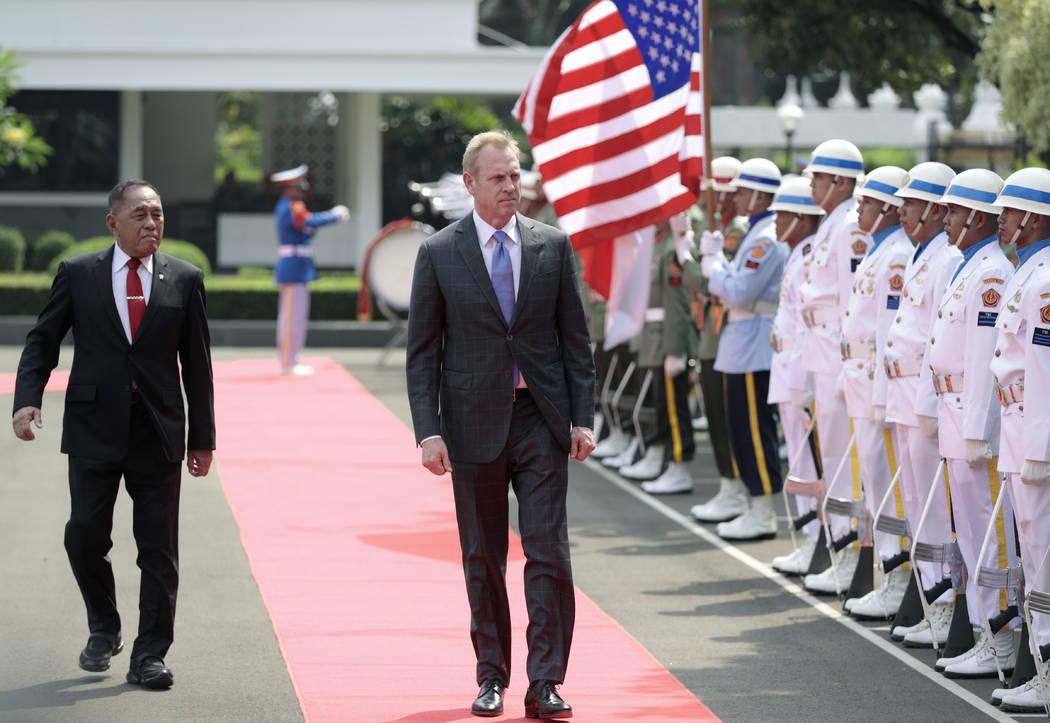 Acting U.S. Secretary of Defense Patrick Shanahan, center, accompanied by Indonesian Defense Mi ...