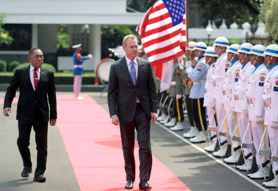 Acting U.S. Secretary of Defense Patrick Shanahan, center, accompanied by Indonesian Defense Mi ...