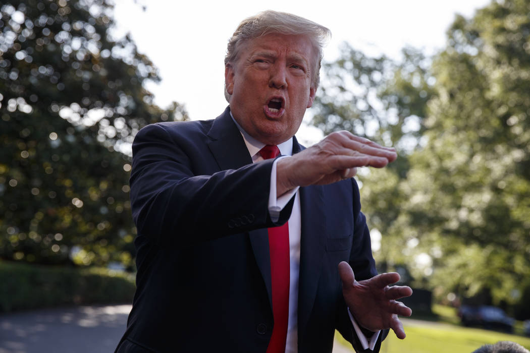 President Donald Trump talks with reporters before departing on Marine One for the Air Force Ac ...