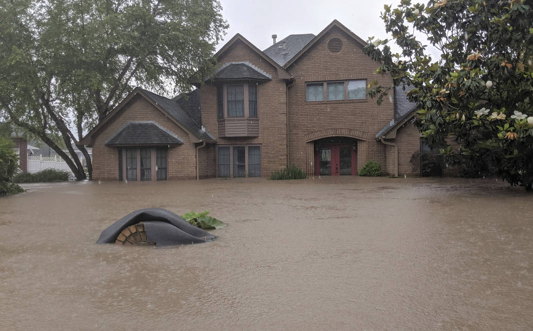 Flood waters surround homes in Fort Smith, Ark., Wednesday, May 29, 2019. Flood waters from the ...