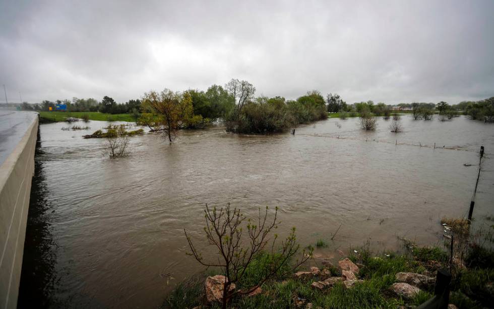 In this Tuesday, May 28, 2019 photo, Rapid Creek overflows its banks on the eastside of Elk Val ...