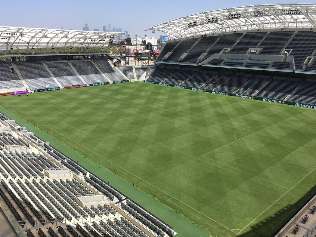 In this Thursday, April 26, 2018, photo workers prepare the playing field at Banc of California ...