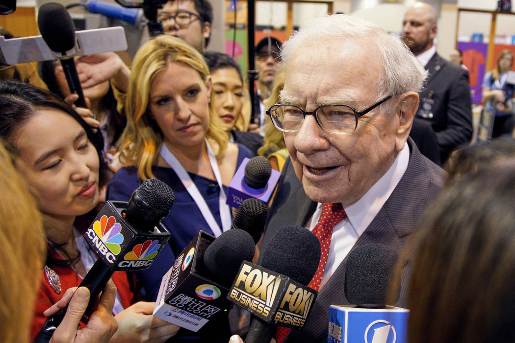 Warren Buffett, Chairman and CEO of Berkshire Hathaway, speaks to reporters during a tour of th ...