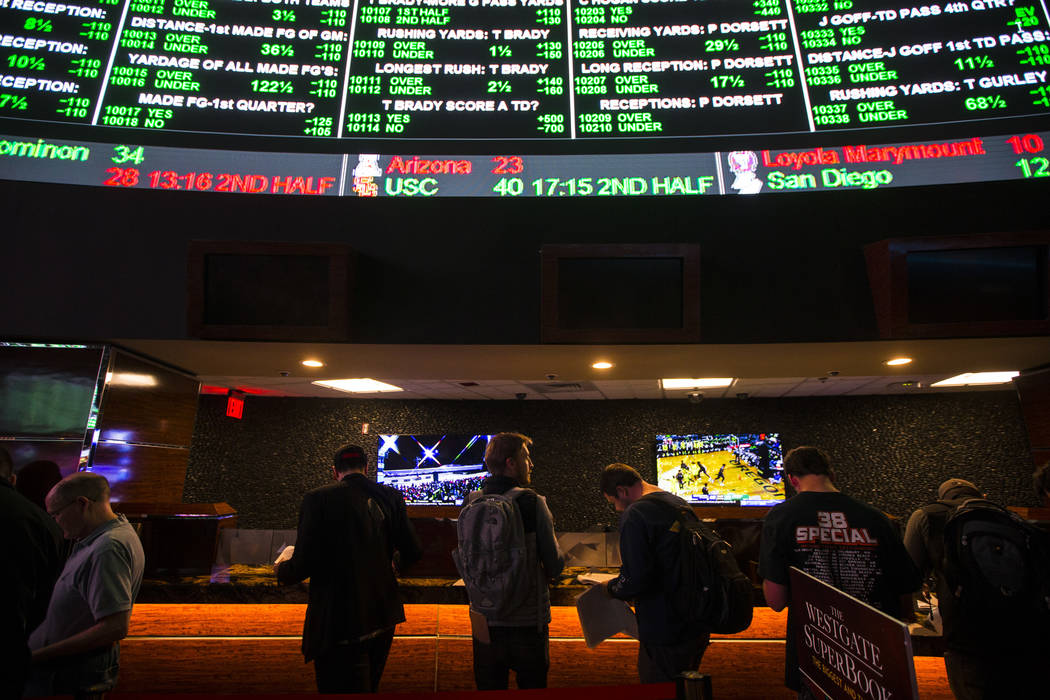 Bettors line up to place prop bets for the Super Bowl at the Westgate Superbook in Las Vegas on ...