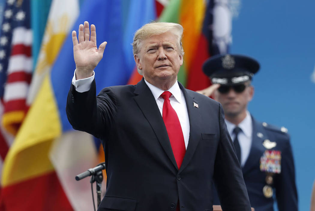 President Donald Trump waves as he takes the stage to speak at the U.S. Air Force Academy gradu ...