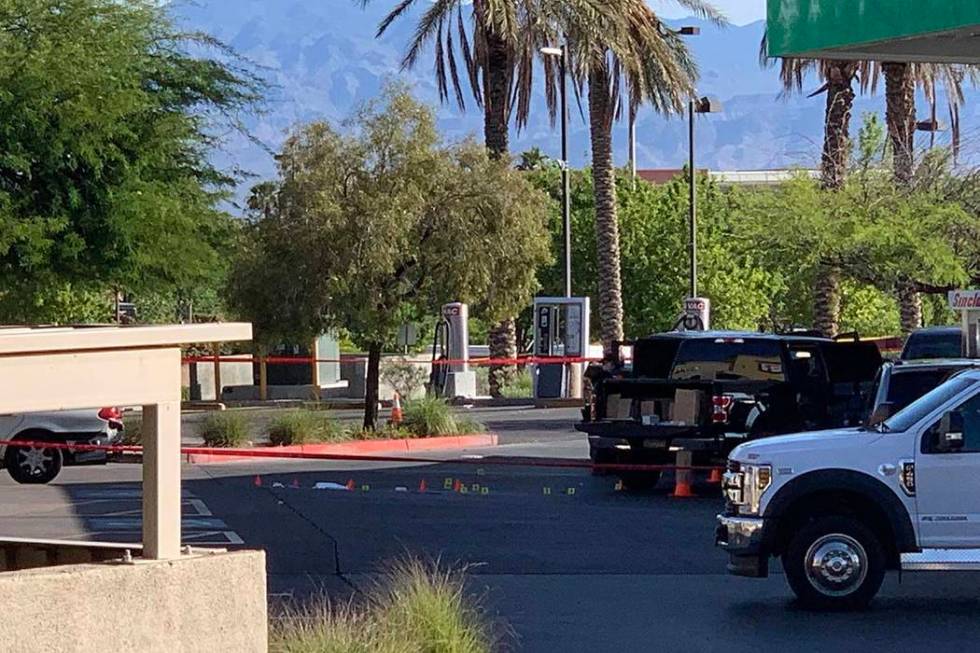 Las Vegas police investigate after an officer-involved shooting at a Sinclair station at Coving ...