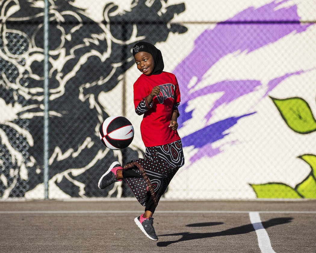 Fardosa Blial, 6, plays with a basketball during a youth clinic hosted by UNLV head basketball ...