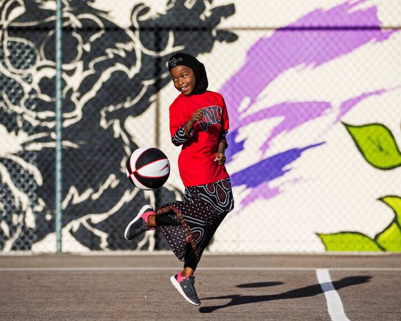 Fardosa Blial, 6, plays with a basketball during a youth clinic hosted by UNLV head basketball ...