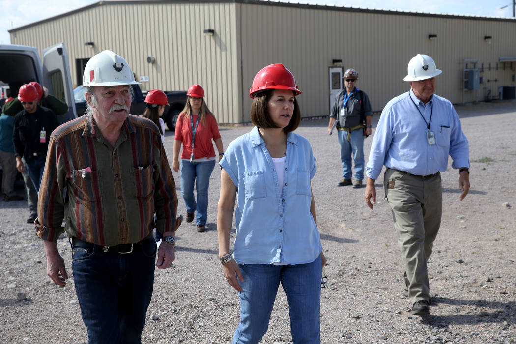 U.S. Sen. Catherine Cortez Masto, D-Nev., walks with Steve Frishman, a technical consultant to ...