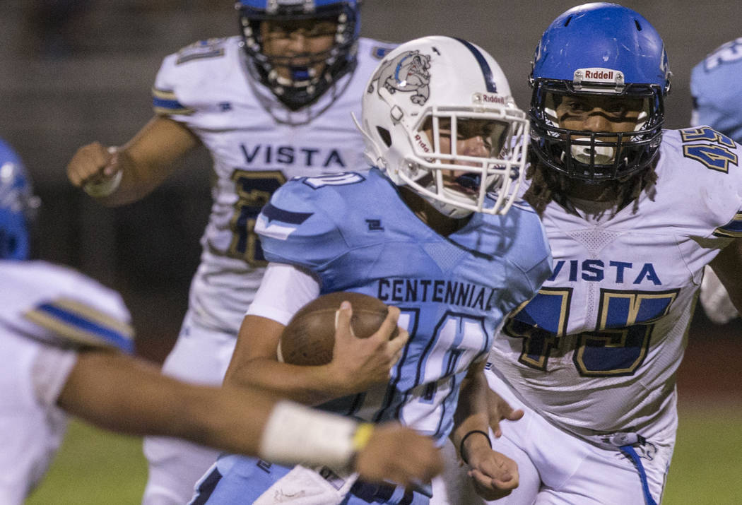 Centennial sophomore quarterback Colton Tenney (10) runs for big yardage against Sierra Vista i ...