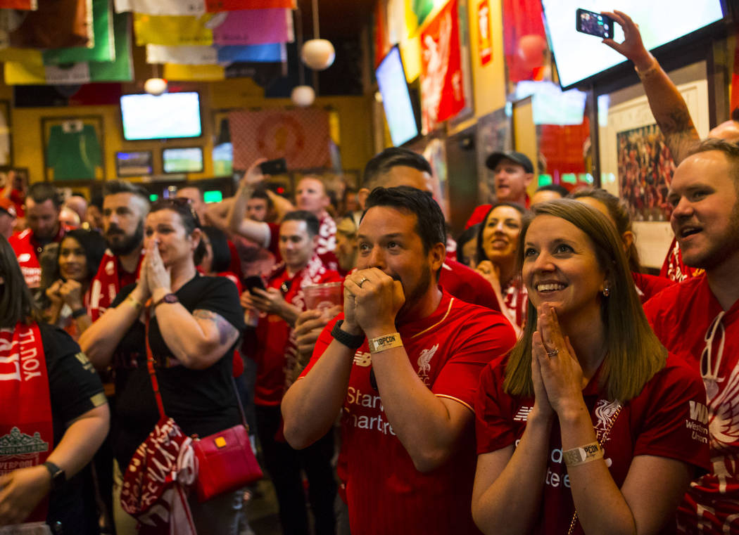 Liverpool fans Lutz Mueller, center, and Emily Mueller, right, both of Los Angeles, react befor ...