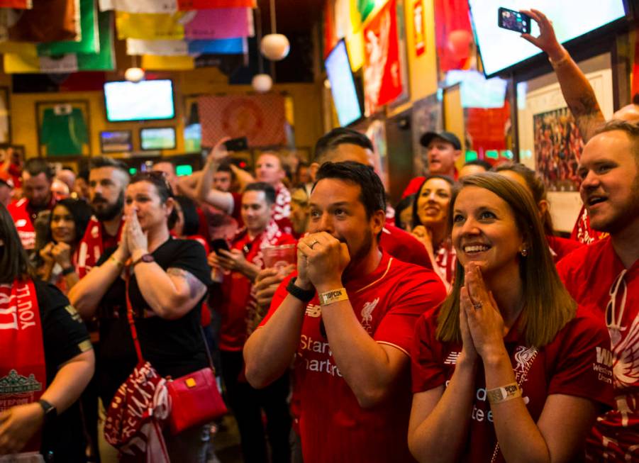 Liverpool fans Lutz Mueller, center, and Emily Mueller, right, both of Los Angeles, react befor ...