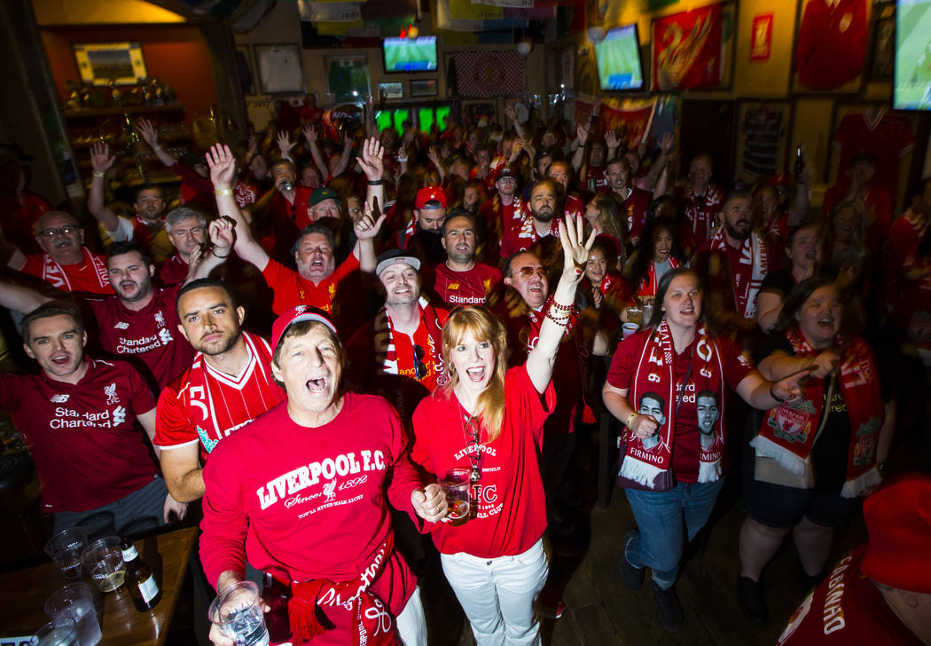Liverpool fans, including Stacey Gualandi, of Las Vegas, center left, celebrate the opening goa ...