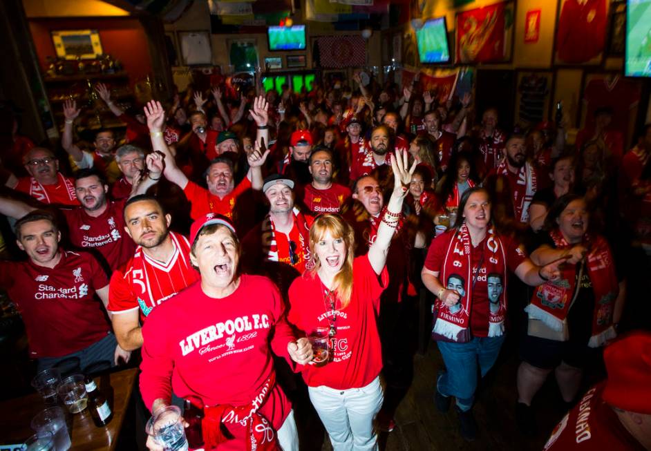 Liverpool fans, including Stacey Gualandi, of Las Vegas, center left, celebrate the opening goa ...