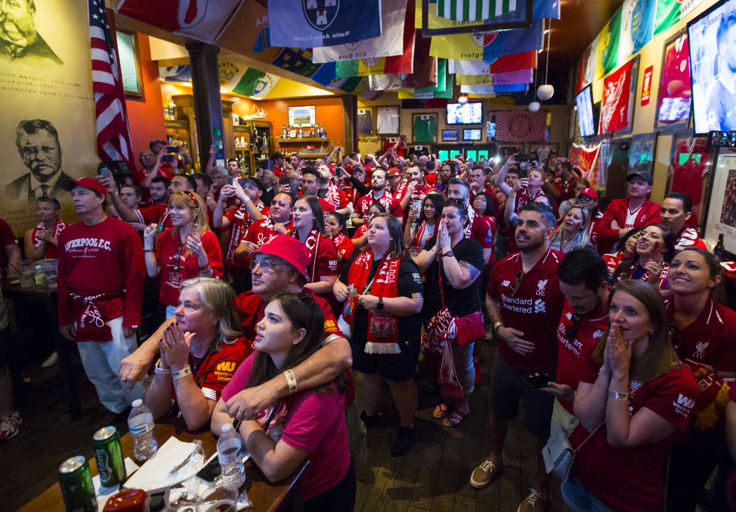 Liverpool fans react during a penalty shot at the start of the Champions League final soccer ma ...