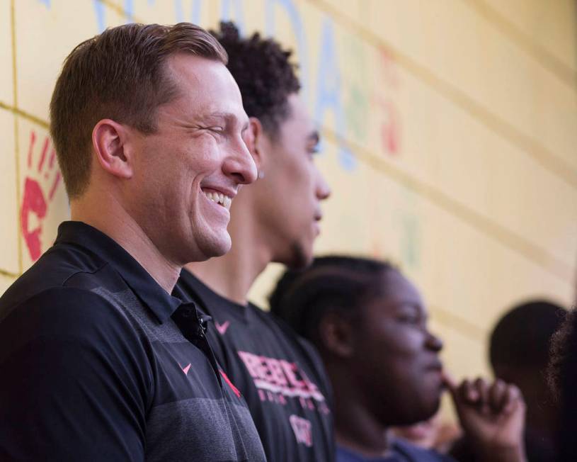 UNLV head basketball coach T.J. Otzelberger, left, jokes around with kids at the Nevada Youth N ...