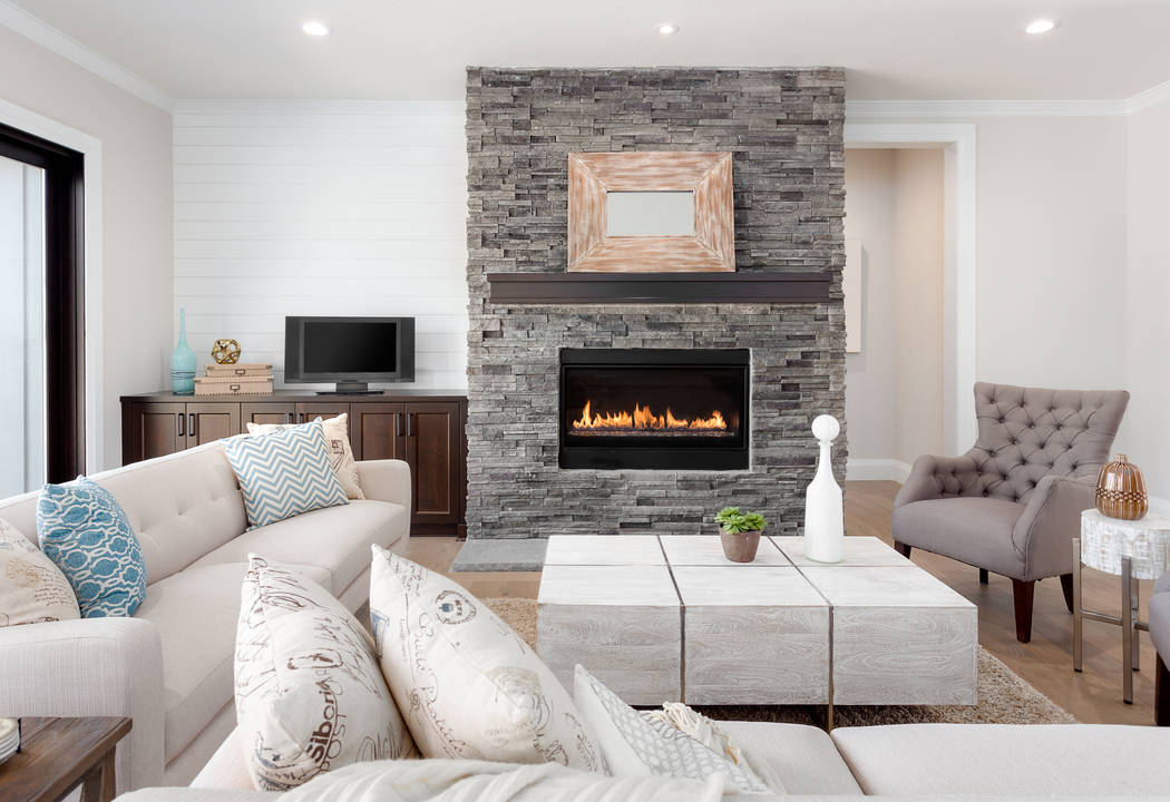 Stone fireplaces are not new, but having the stone go floor to ceiling is especially popular no ...