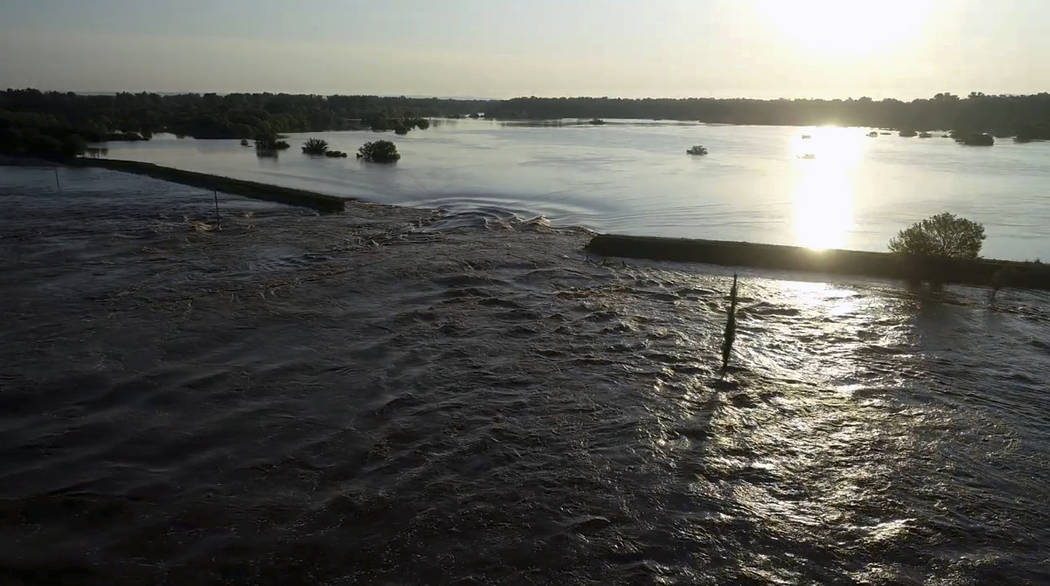 In this aerial image provided by Yell County Sheriff's Department water rushes through the leve ...