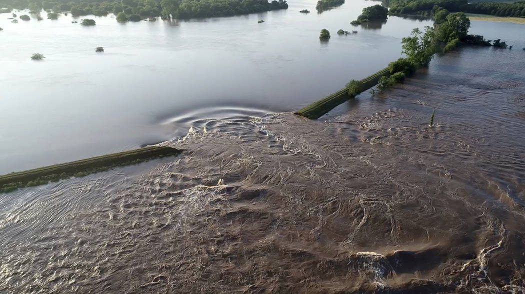 In this aerial image provided by Yell County Sheriff's Department water rushes through the leve ...