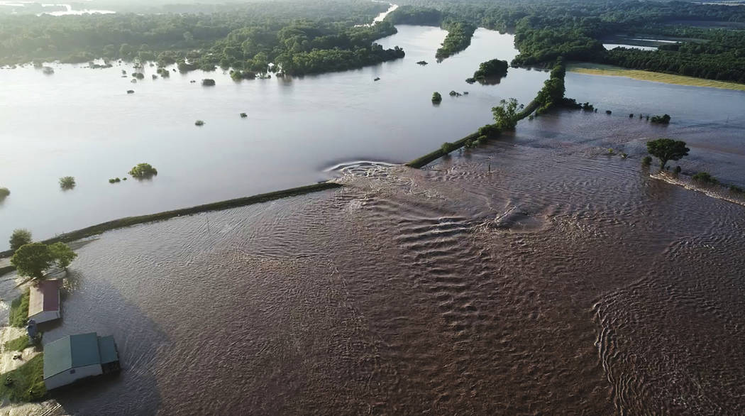 In this aerial image provided by Yell County Sheriff's Department water rushes through the leve ...