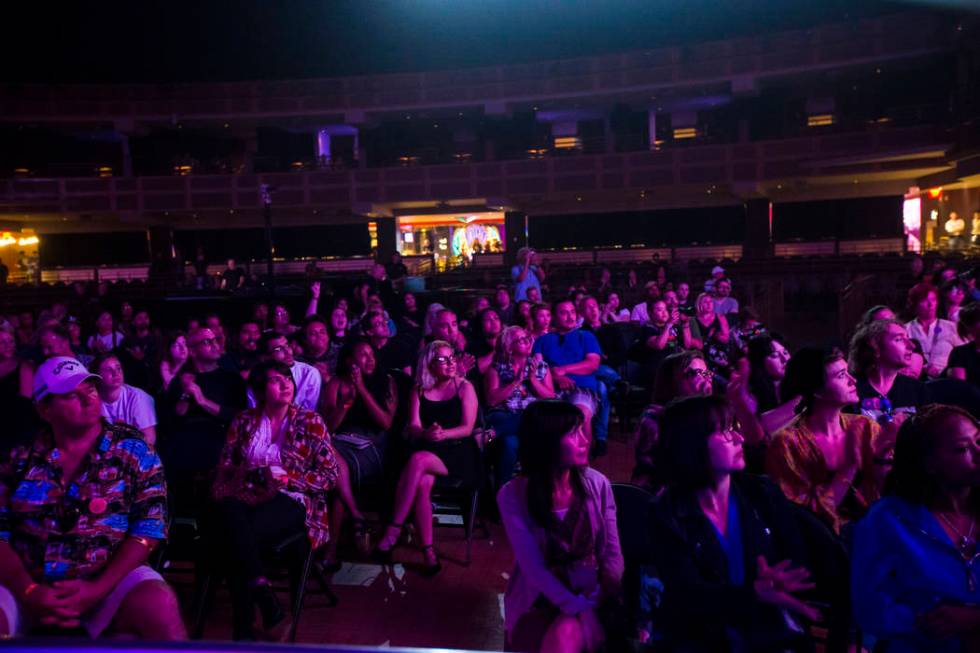 Attendees listen to host John Forte, not pictured, inside The Joint during the first day of the ...