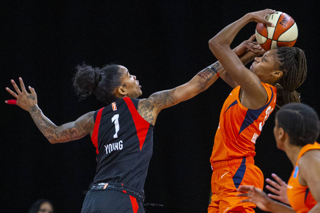 Las Vegas Aces forward Tamera Young (1) defends the basket from Connecticut Sun guard Bria Holm ...