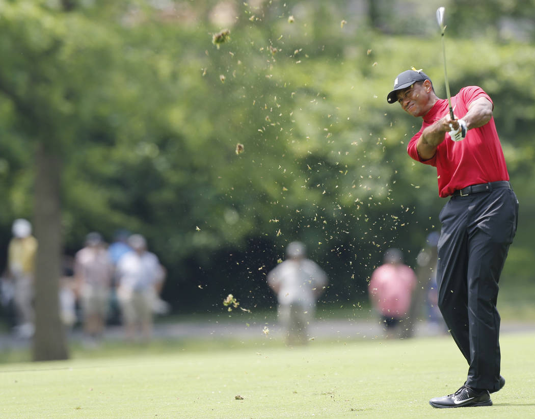 Tiger Woods hits his approach shot on the second hole during the final round of the Memorial go ...