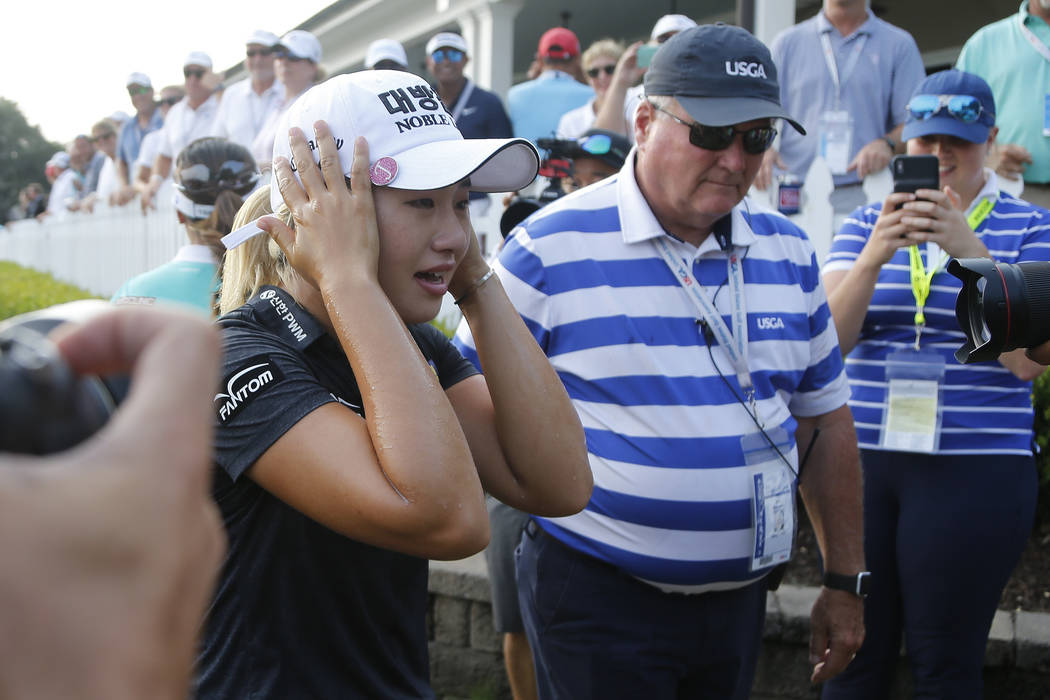 Jeongeun Lee6 of South Korea, reacts to being doused with Champagne after winning the final rou ...