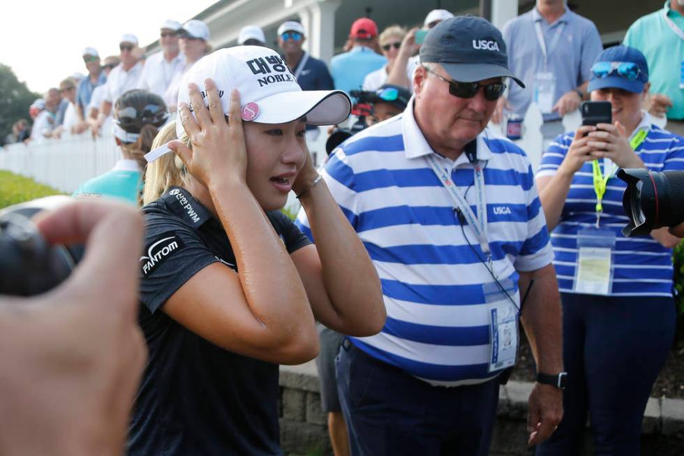 Jeongeun Lee6 of South Korea, reacts to being doused with Champagne after winning the final rou ...