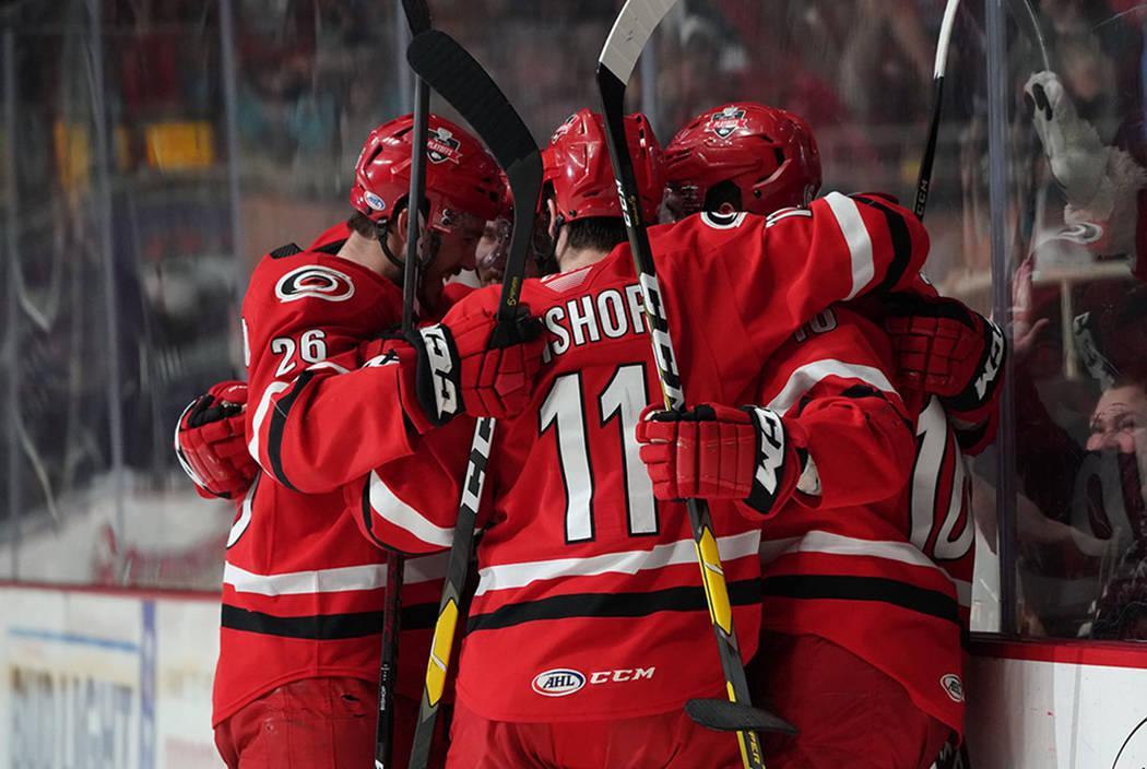 Charlotte Checkers players celebrate after scoring a goal against the Chicago Wolves in Game 2 ...