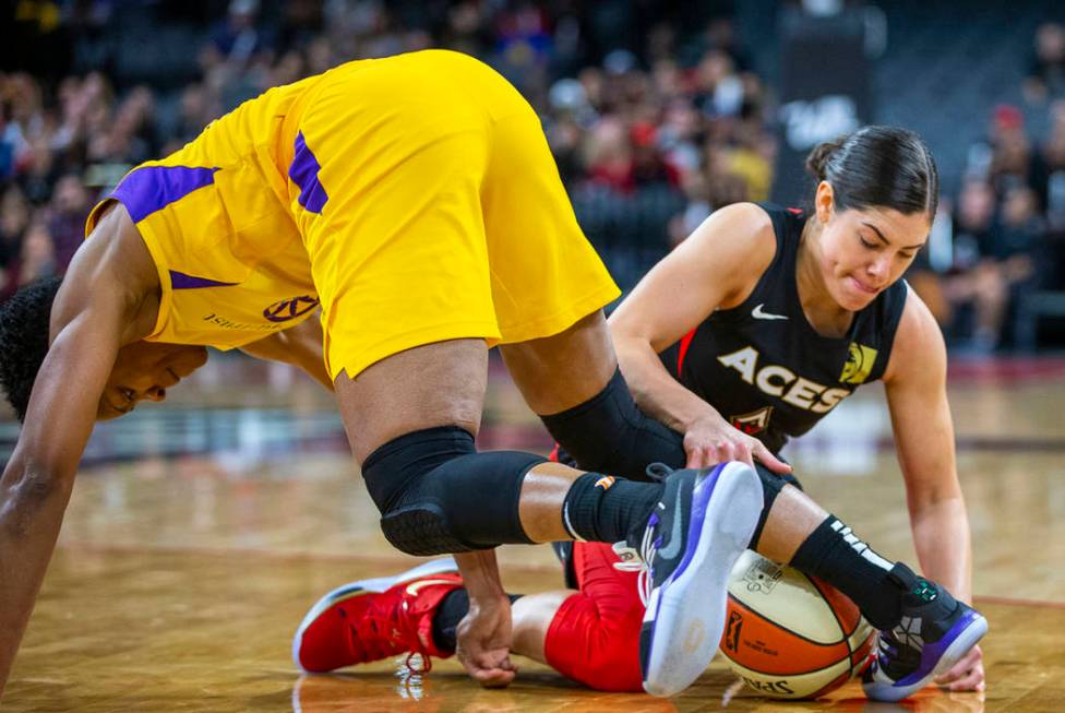 Los Angeles Sparks guard Alexis Jones, left, loses the ball to Las Vegas Aces guard Kelsey Plum ...