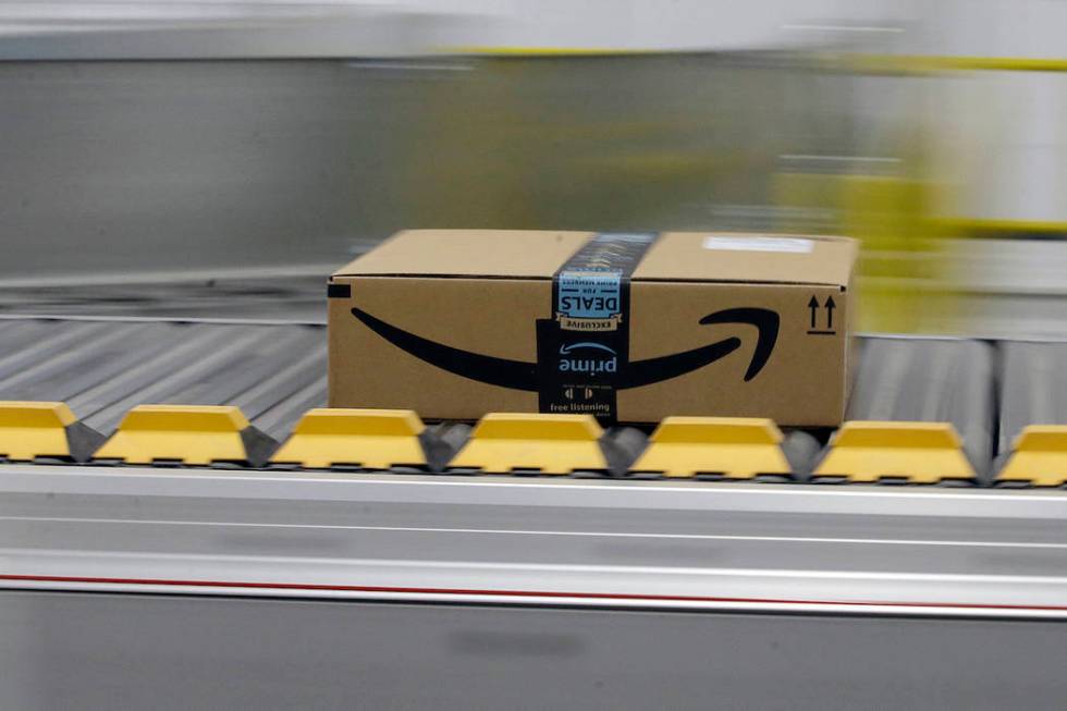 A box for an Amazon prime customer moves through the new Amazon Fulfillment Center in Sacrament ...