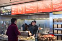 In this Dec. 15, 2015 file photo, a Chipotle Mexican Grill employee, right, prepares a burrito ...