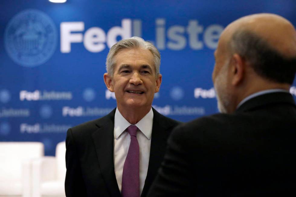 Federal Reserve Chairman Jerome Powell, left, talks to former Federal Reserve Chairs Ben Bernan ...