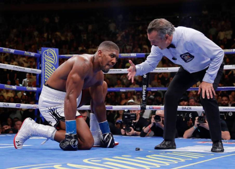 Anthony Joshua waits during the referee's count after he was knocked down during the seventh ro ...