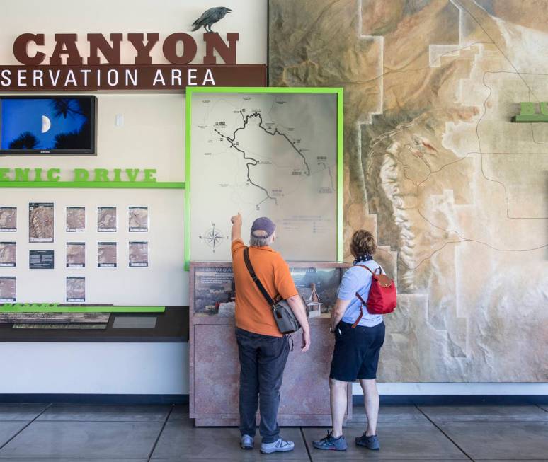 A couple looks over a map at the visitor center during "National Get Outdoors Day" at ...