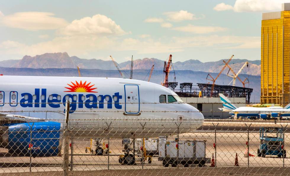 An Allegiant Air plane sits on the tarmac at McCarran International Airport in Las Vegas with t ...