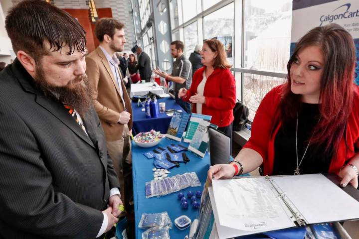 In a March 7, 2019, file photo visitors to the Pittsburgh veterans job fair meet with recruiter ...