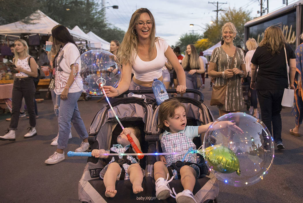 Danielle Kovacs, top/middle, pushes sons Christoper, left, 1, and Johnny, 2, during First Frida ...
