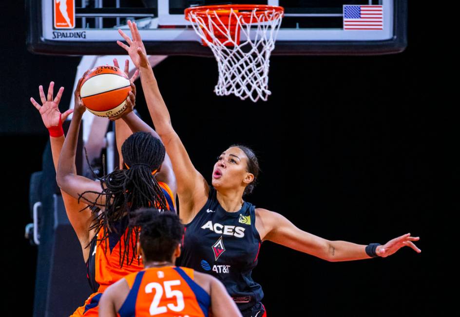 Connecticut Sun forward Jonquel Jones (35) has a shot attempt blocked by Las Vegas Aces center ...