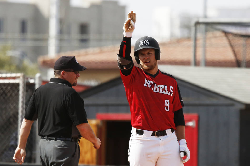 UNLV outfielder Max Smith (9) signals to his team after hitting a triple against Air Force at t ...