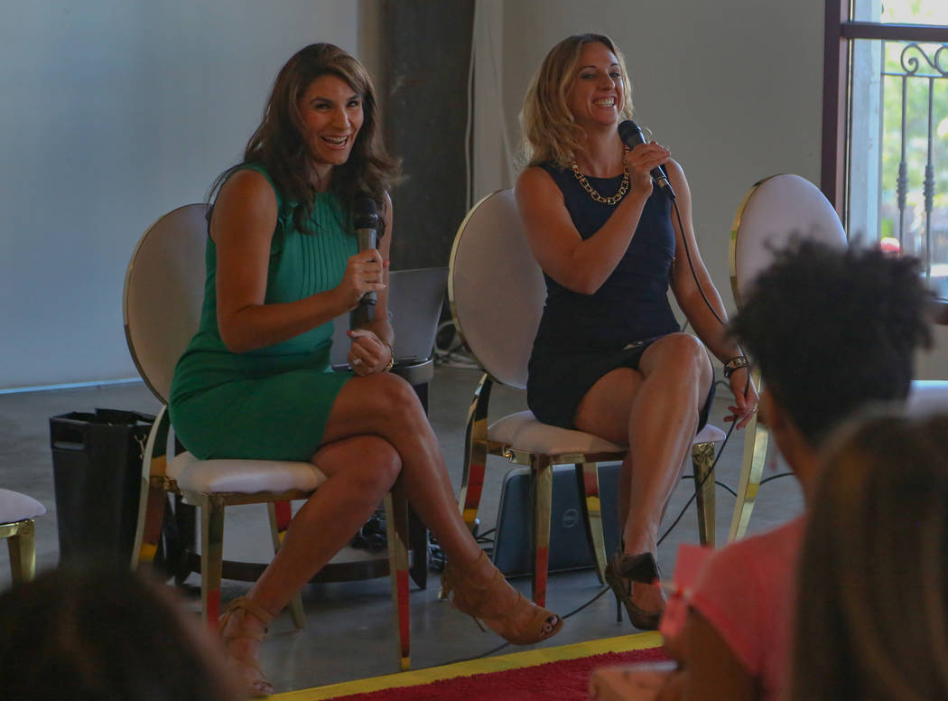 Paola Armeni, left, and Jaime Kobzelman share a laugh while speaking during the Manifest Summit ...