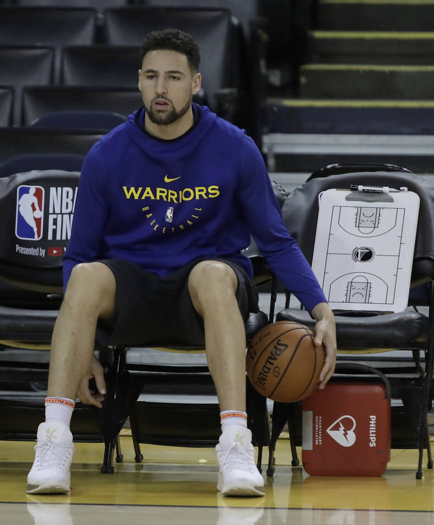 Golden State Warriors' Klay Thompson sits on the bench during practice for the NBA Finals again ...