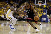 Toronto Raptors forward Kawhi Leonard (2) dribbles against Golden State Warriors forward Alfonz ...