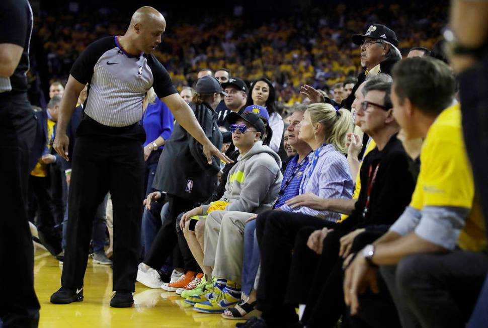 In this photo taken Wednesday, June 5, 2019, referee Marc Davis, left, gestures toward Golden S ...