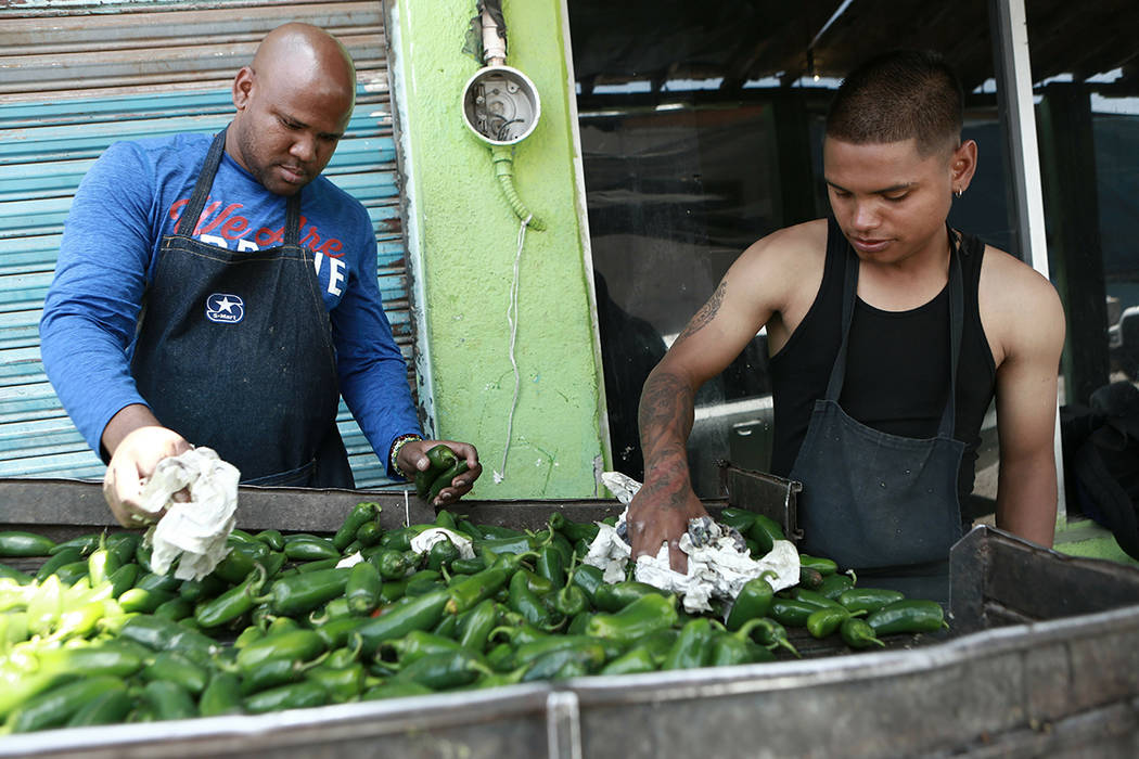 Workers prepare peppers for export from Mexico to the United States, in Ciudad Juarez, Mexico, ...